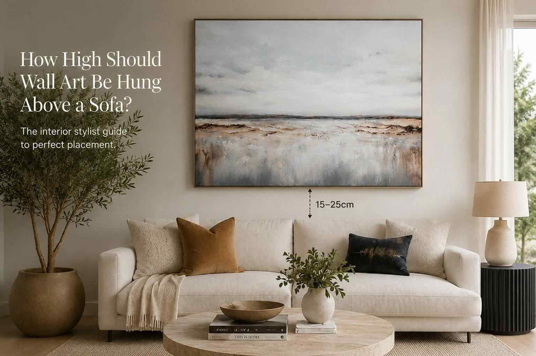 Wall art positioned above a sofa at the recommended hanging height